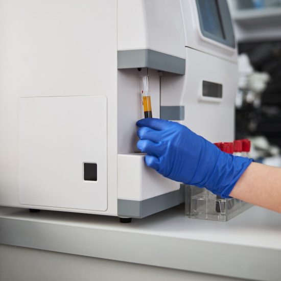 Biochemist using a hematology analyzer for conducting a hematological test